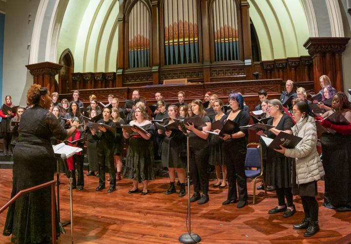 PSU Choirs singing in a church conducted by Coty Raven Morris