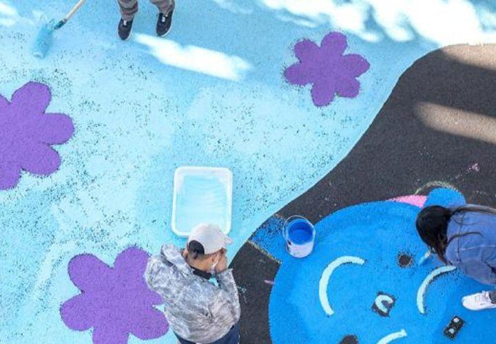 PSU students painting a street mural.