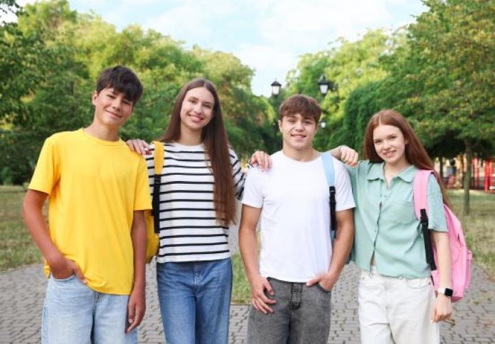 Four students posed and smiling.