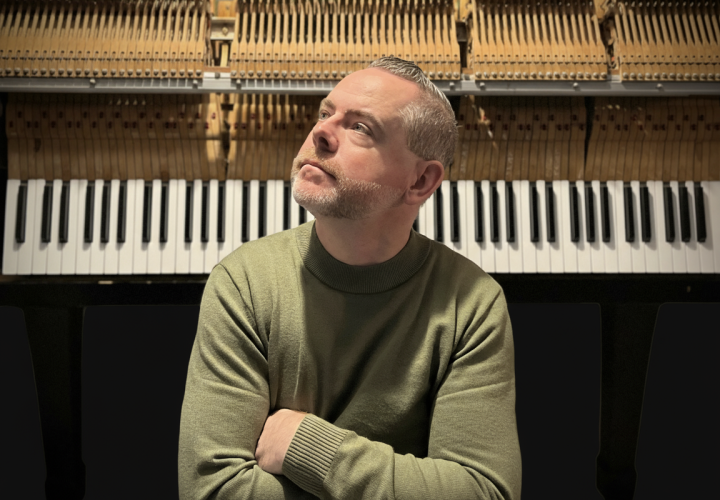 PSU Steinway series guest artist Chad R. Bowles posed in front of a piano