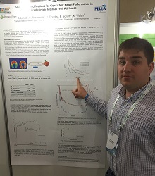 Ryan Lerud pointing to his poster presentation