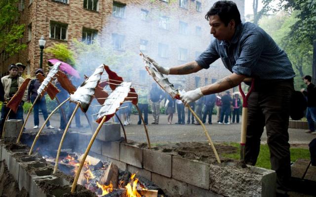 Student preparing salmon during a salmon bake