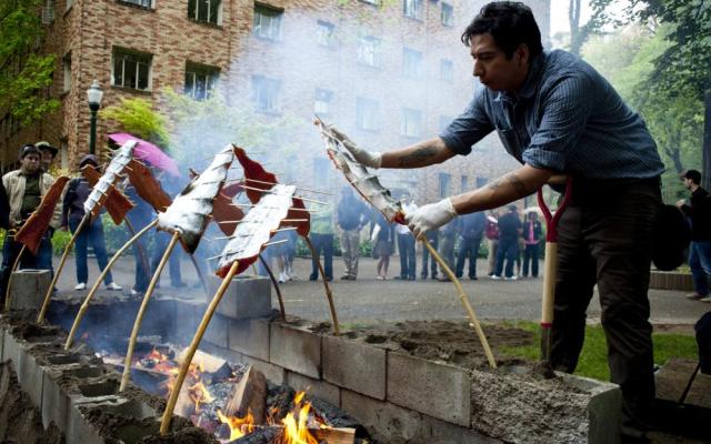 Student preparing salmon during a salmon bake