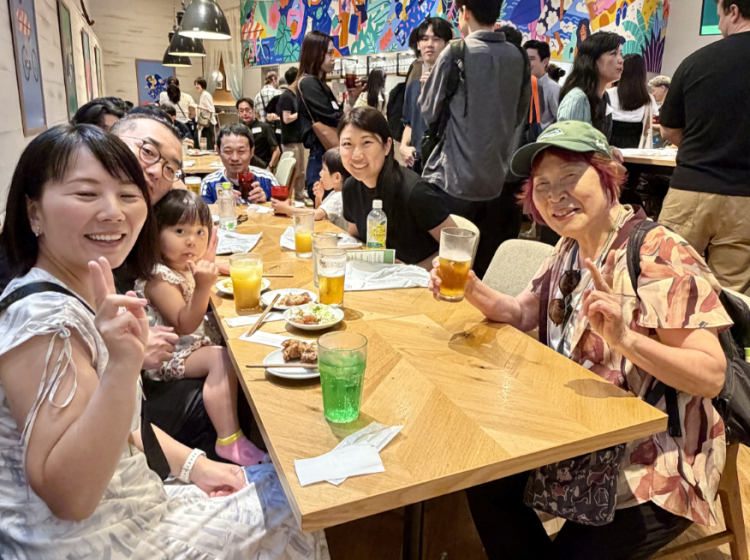 PSU alum sits with their family members during the Tokyo Reunion
