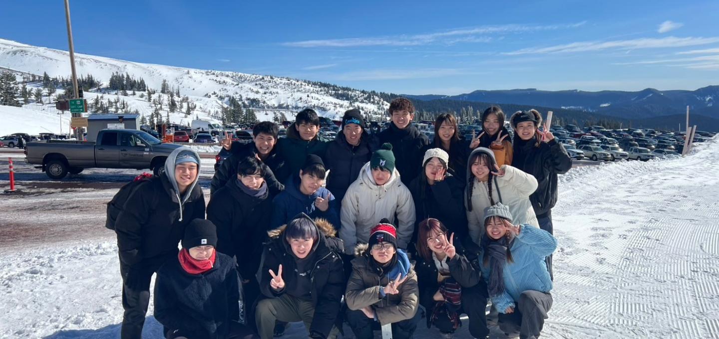 Group of students posing in snow field at Mt Hood.