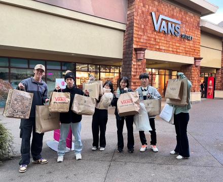 Students with shopping bags at Outlet Mall