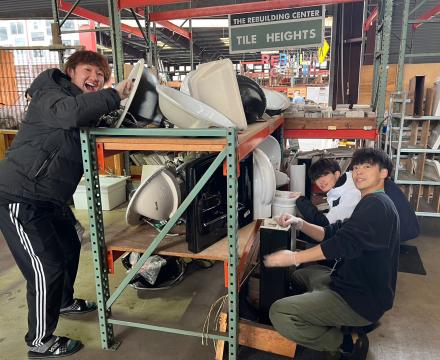 Students cleaning housing materials at The Rebuilding Center