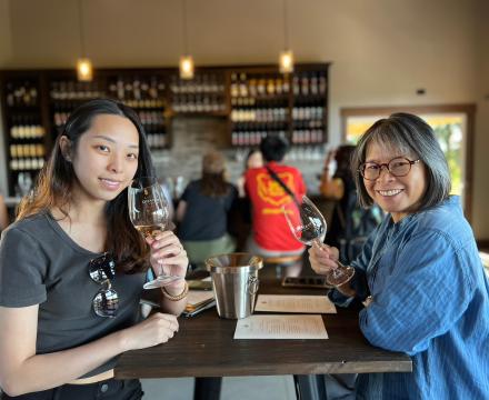 Guests wine tasting at vineyard