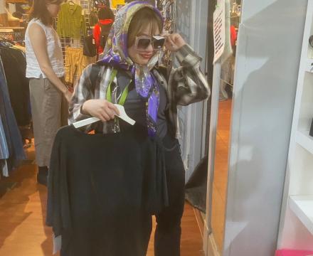 Student trying on thrift clothes