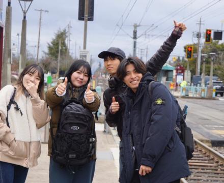 Students giving a thumbs up to the camera