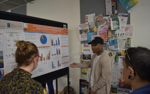 Student presenting research poster