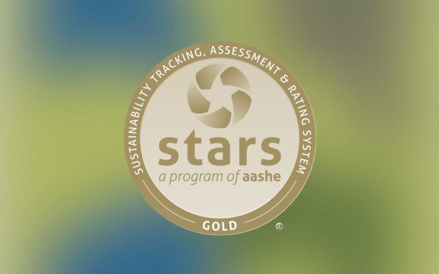 picture of a gold circle with the words "sustainability tracking, assessment & rating system gold" on the outside of the circle and "stars a program of aashe" in the middle
