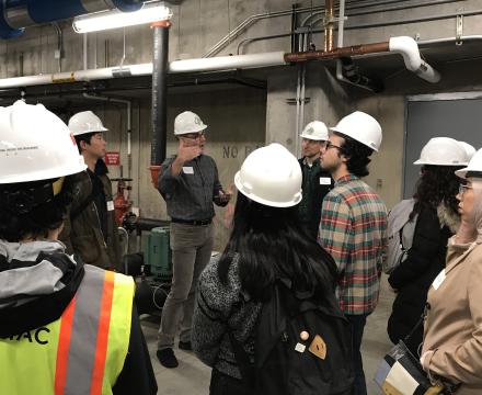 students in hard hats in mechanical room of student rec center