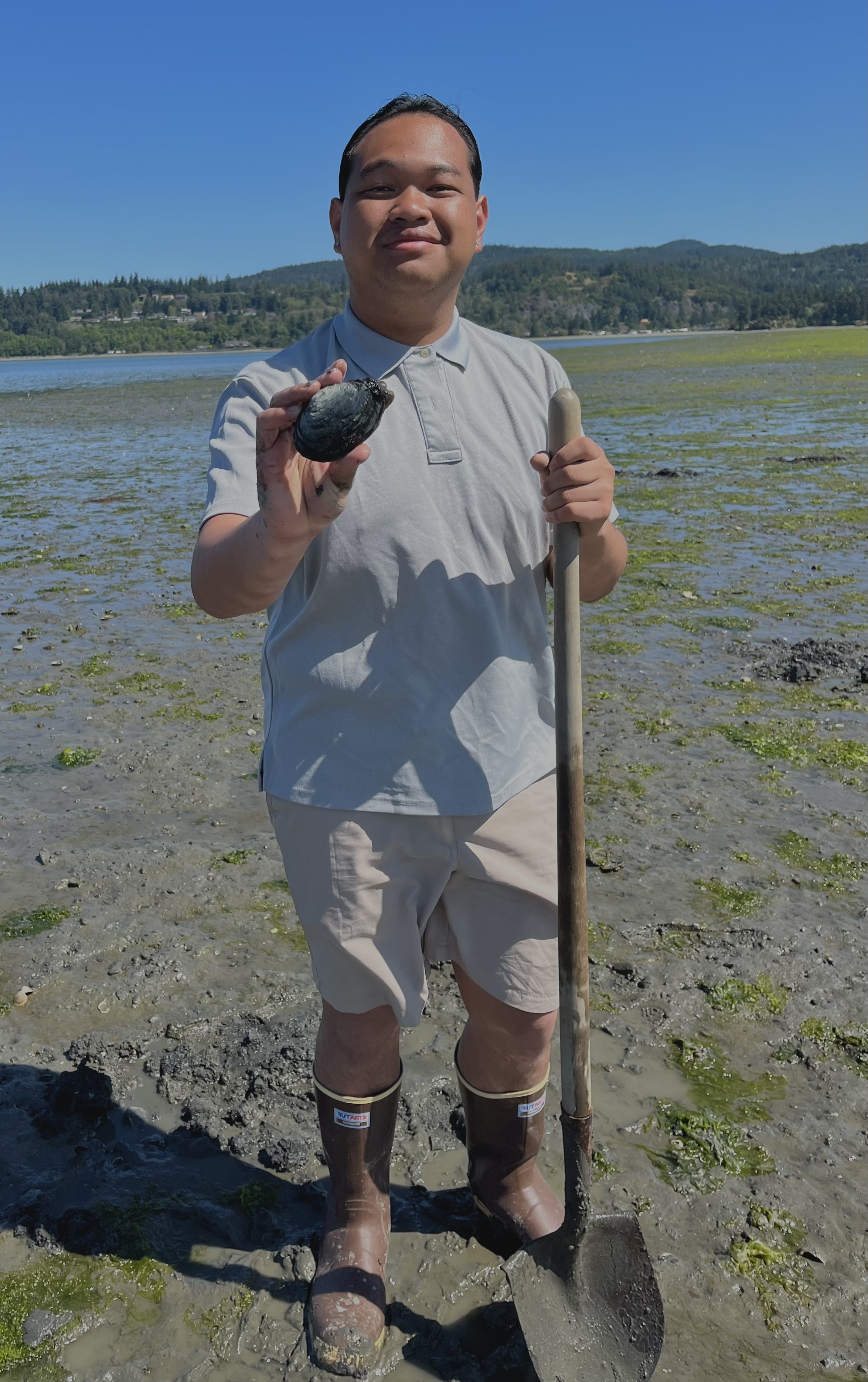 Angel posing with a shovel and shellfish