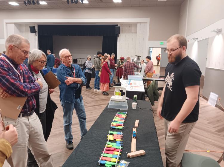 Riley presenting to three people