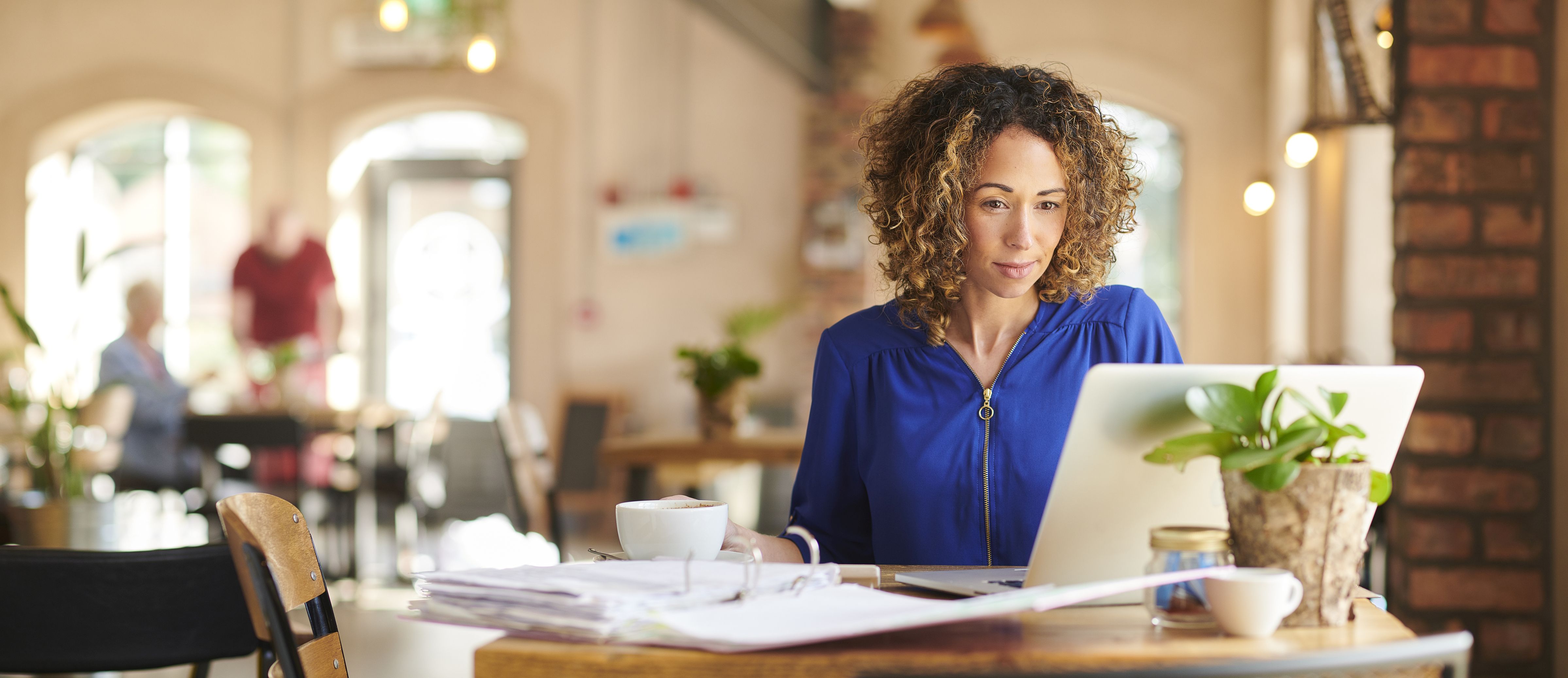 Woman with laptop at coffee shop