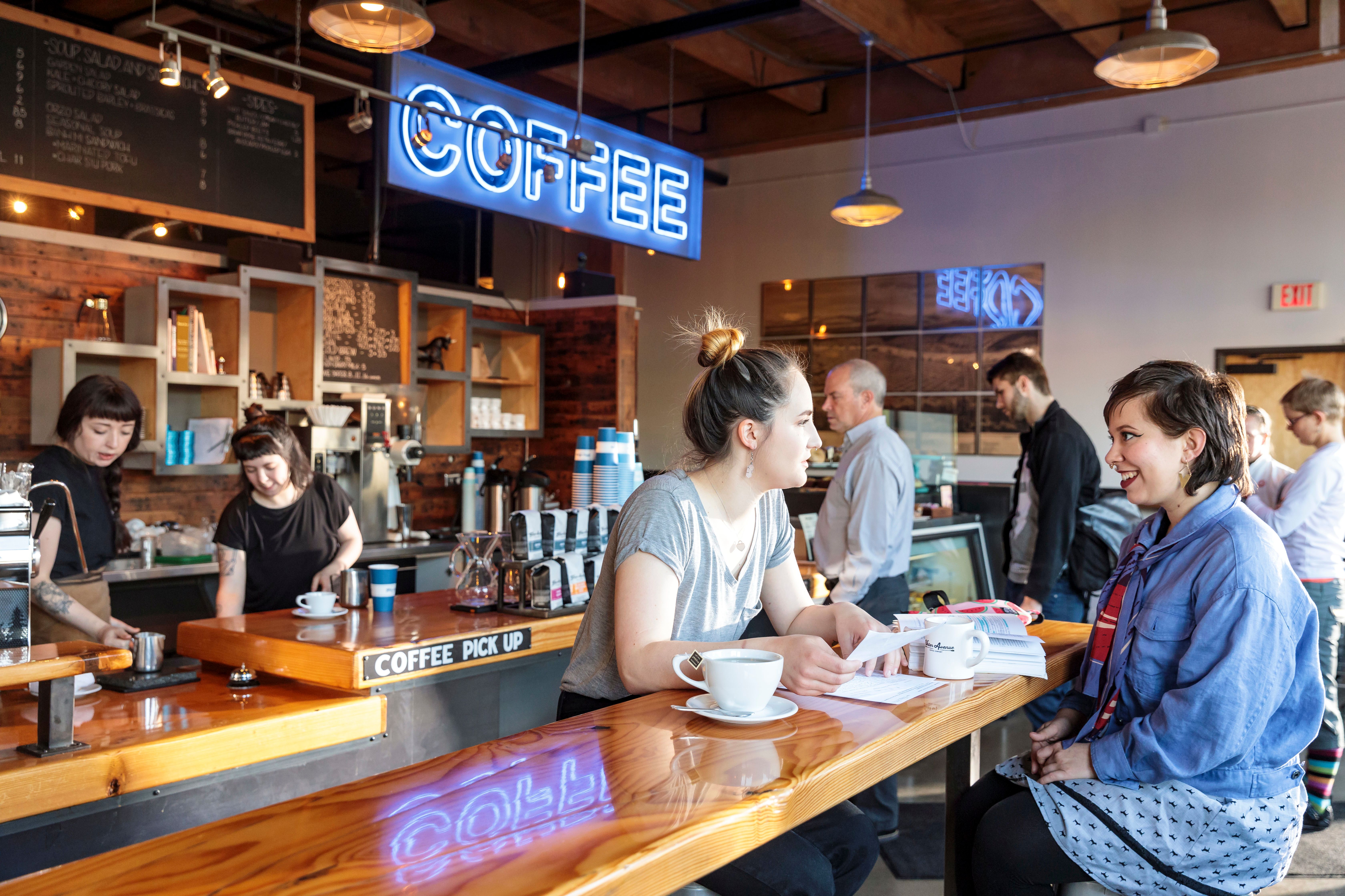 two women talk at coffee shop