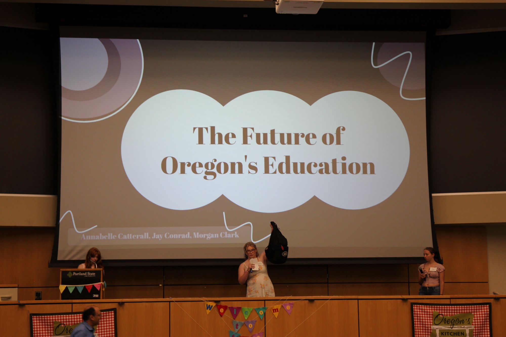The Illinois Valley High School presenting at the 2026 Hatfield Futures Showcase. Behind them, their presentation reads, "The Future of Oregon's Education."