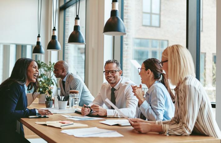 Group of people around a table discussing an issue
