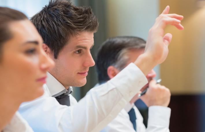 Man raising his hand at a training session