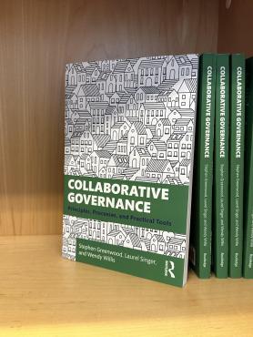 Collaborative Governance textbooks on a shelf.