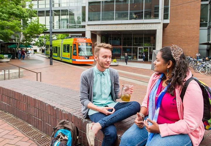 Two PSU students talking in front of the Urban Center