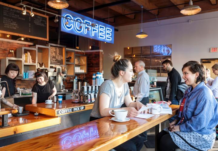 two women talk at coffee shop