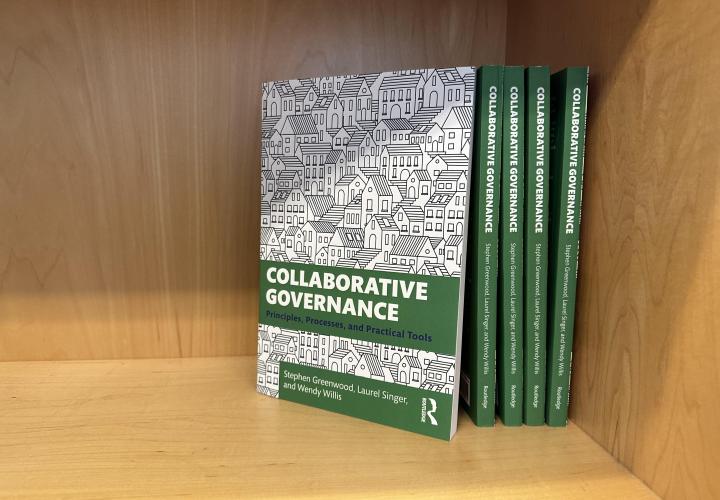 Collaborative Governance textbooks on a shelf.