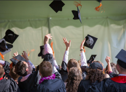 Students throwing caps at graduation