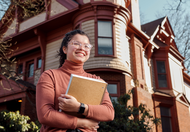 student holding a book