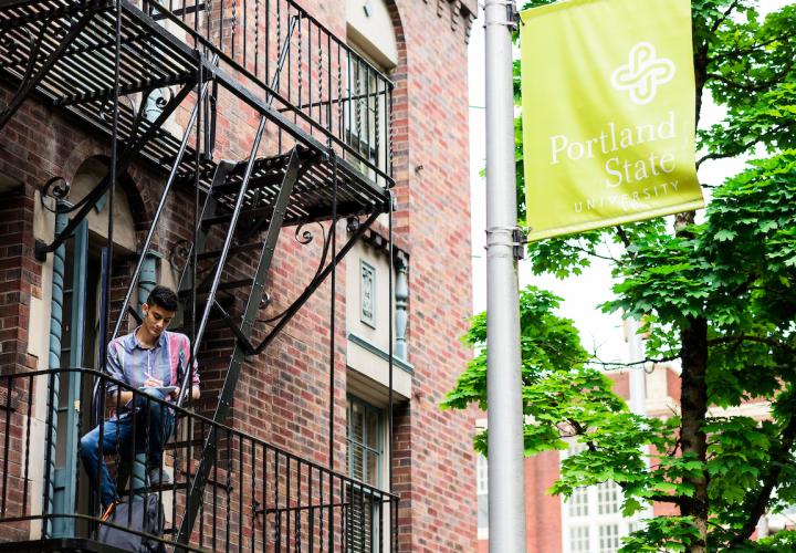 Male student studying on apartment balcony