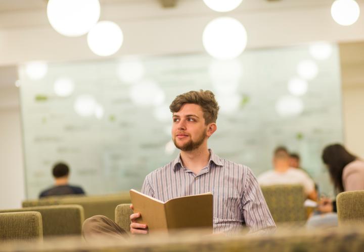 student holding book