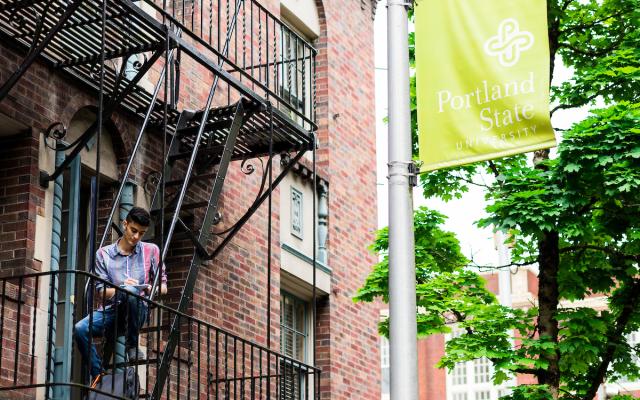 Male student studying on apartment balcony