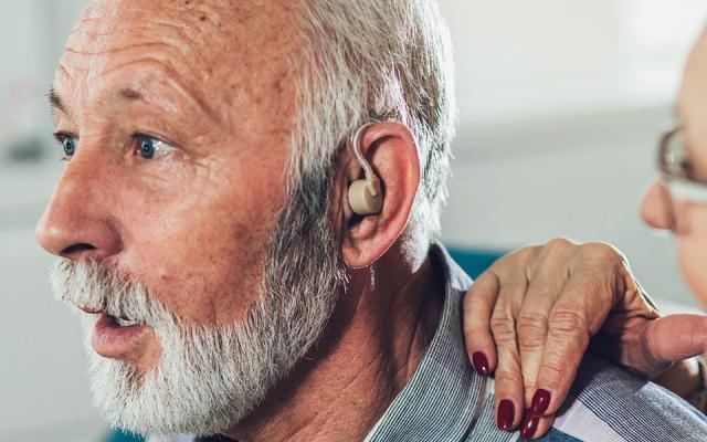 PSU speech and hearing faculty member working with a client