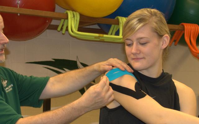 PSU physical therapy student working with a faculty member