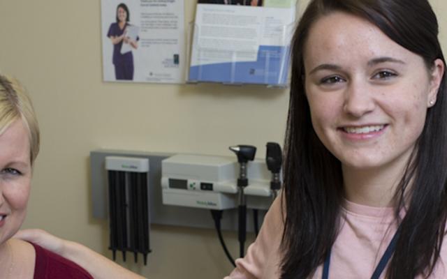 PSU nursing student working in clinic with a patient