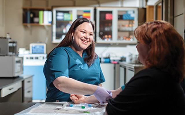 A nurse drawing blood from a patient