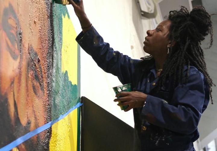 Woman working on a painting