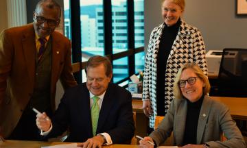 Left to right in President Cudd's office, College of the Arts Dean Leroy Bynum, Jordan Schnitzer (seated), PSU Foundation President Sarah Schwarz, PSU President Ann Cudd (seated).