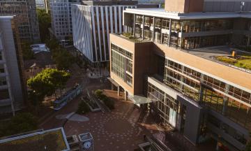 A drone shot showing buildings and PSU's urban plaza on a sunny spring day. 
