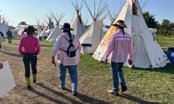 PSU President Ann Cudd, Executive Director of Tribal Relations Modesta Minthorne and Maseeh College of Engineering and Computer Science Dean Joe Bull walking through the Indian Village at the 2025 Pendleton Round-Up in September.