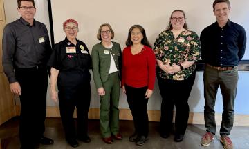A row of people smiling with President Ann Cudd in the middle. 