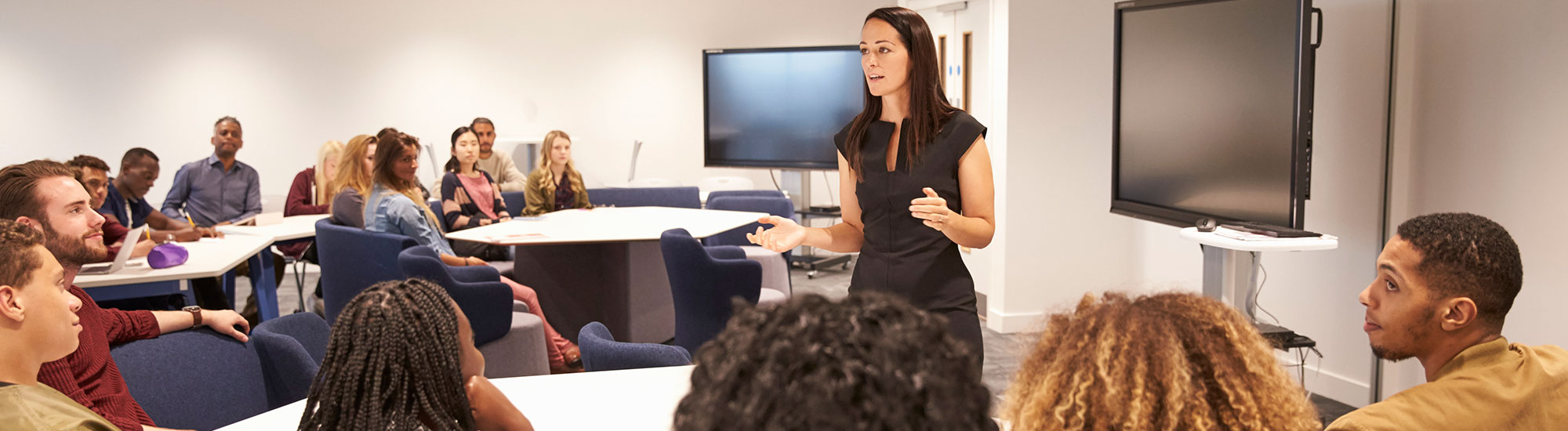 A teacher leading a class and talking to students