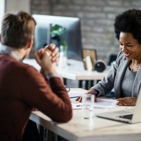 3 people smiling in a meeting 