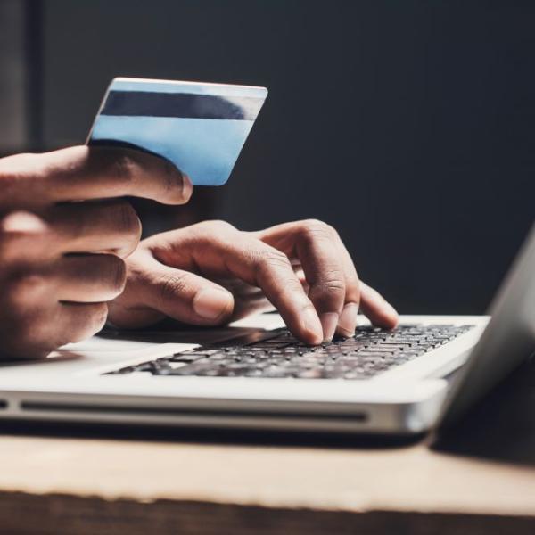 A person with a laptop purchasing an item online.