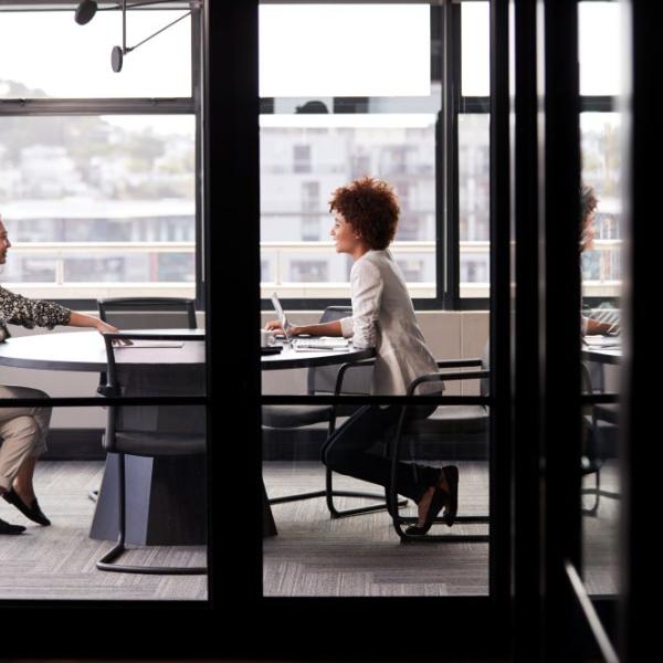 Two people at a table conversing.