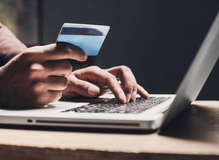 A person with a laptop purchasing an item online.