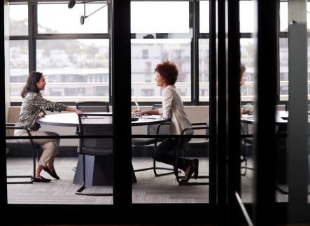 Two people at a table conversing.