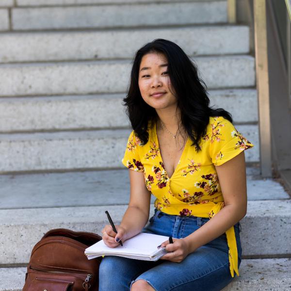 PSU student studying sitting on some stairs