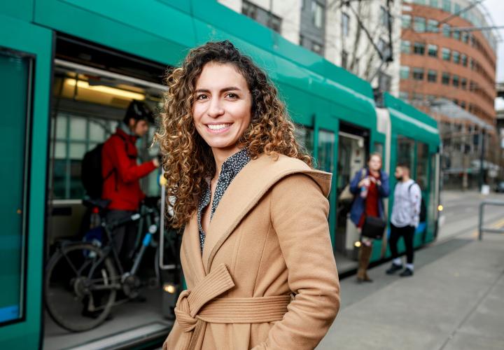 Portland State University urban and public affairs student getting on the Max